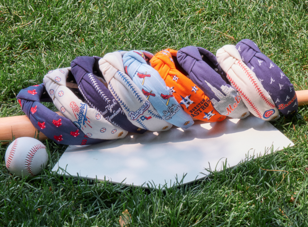 The Lele Sadoughi X MLB Collaboration capsule collection features 18 headbands celebrating nine baseball teams.