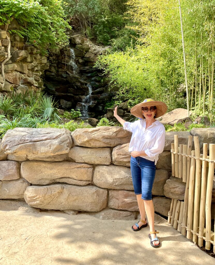 Ramona Bass points to a waterfall, she calls one of the zoo's follies. (Photo by Courtney Dabney)