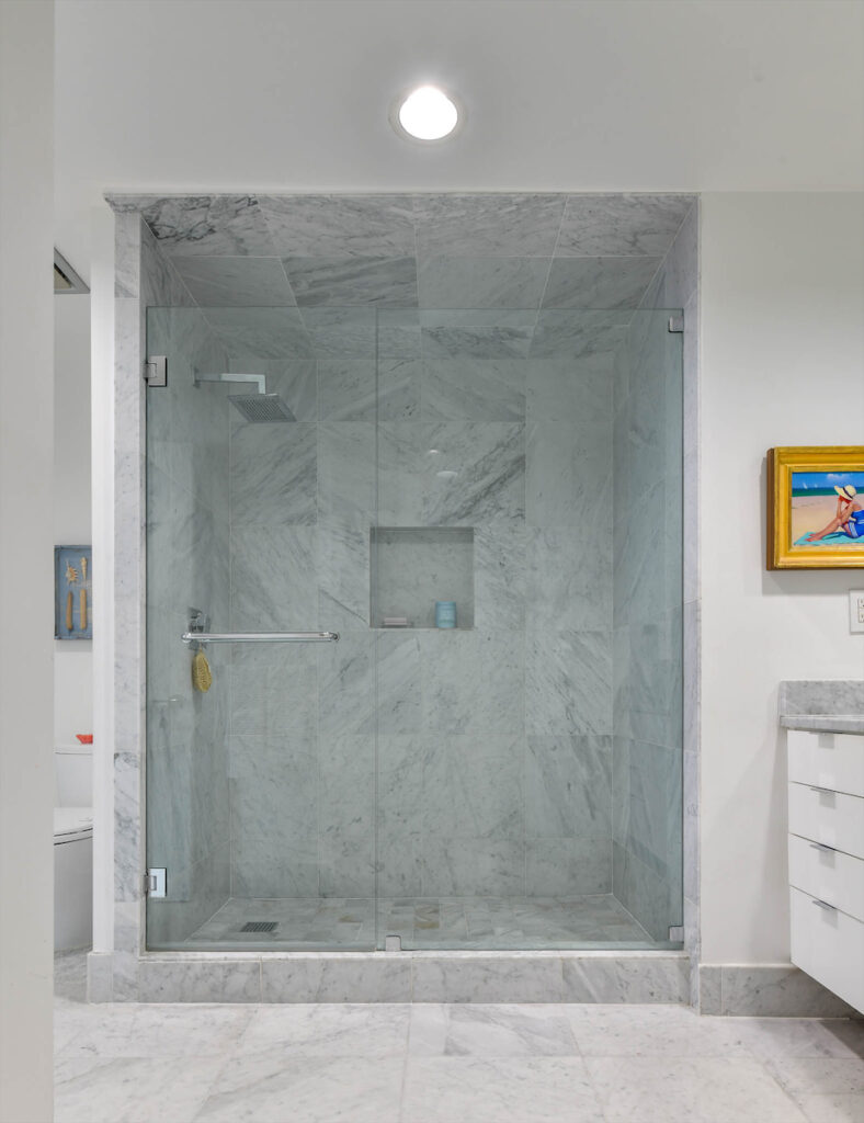 A marble shower in the master bath. 