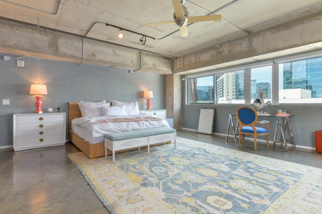 The master bedroom features Caitlin Wilson grasscloth wallpaper throughout. 