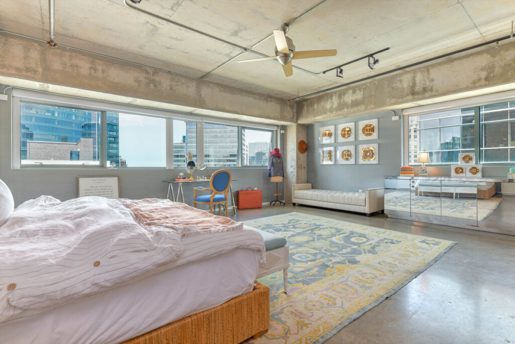 The master bedroom features Caitlin Wilson grasscloth wallpaper throughout. 
