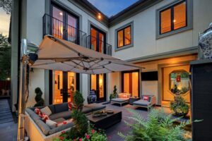 The primary outdoor entertaining space in the luxurious 'Tuscan Villa' townhome at 5722 Logan Lane (Photo by TK Images/Compass)