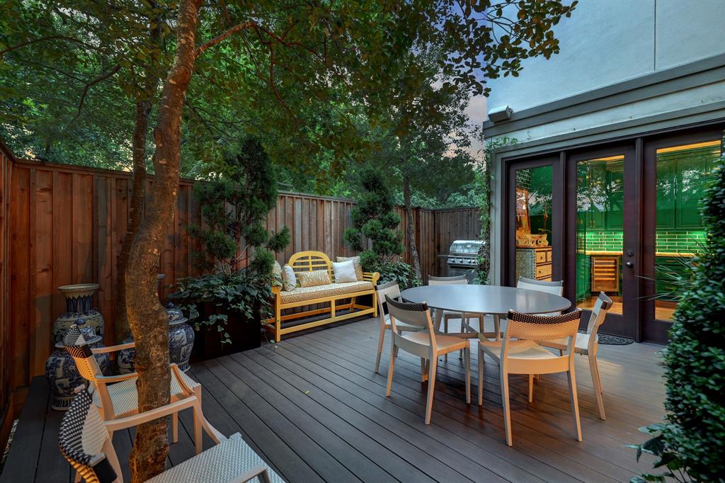 The informal deck off of the kitchen in the luxurious 'Tuscan Villa' townhome at 5722 Logan Lane (Photo by TK Images/Compass)