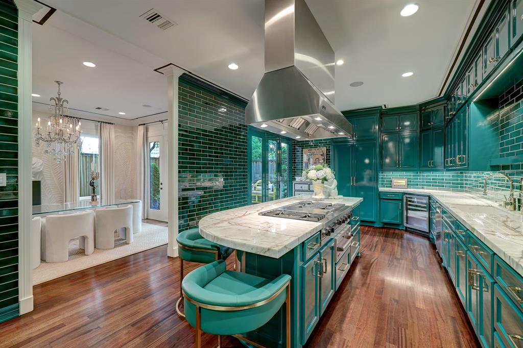 The emerald green kitchen, despite the turquoise photo shading, in the luxurious 'Tuscan Villa' townhome at 5722 Logan Lane (Photo by TK Images/Compass)