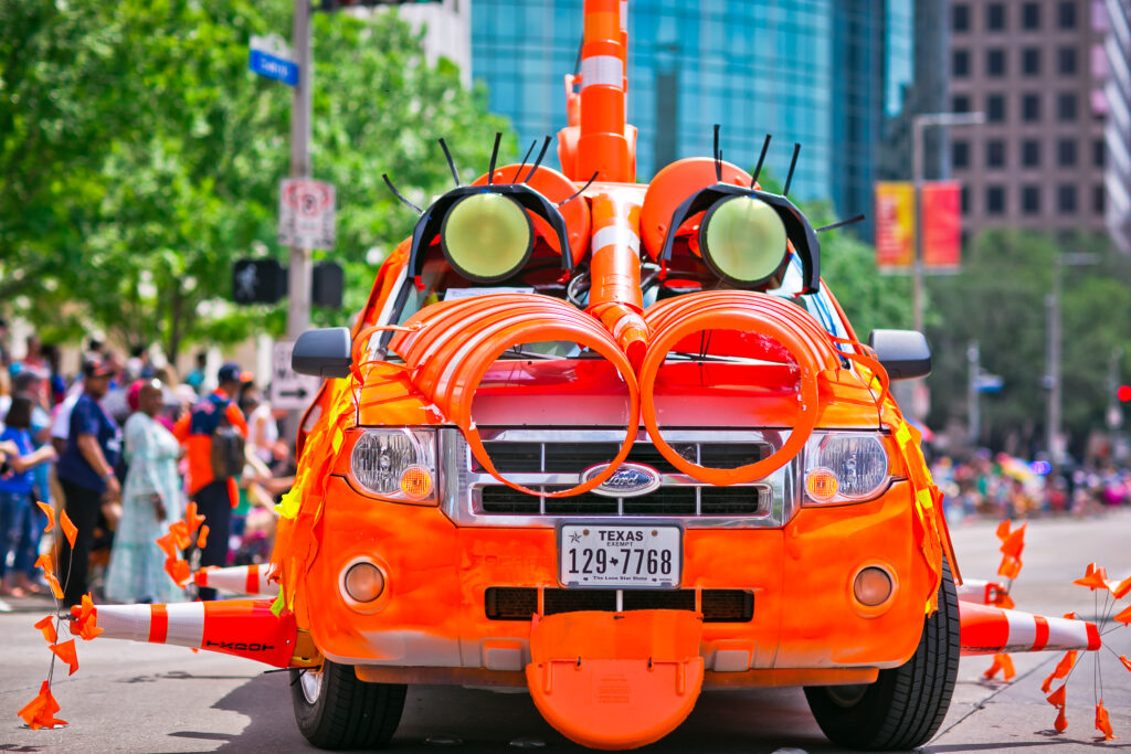 The 2023 Orange Show Art Car Parade, featuring cars like "Traffic Cone Safety Monster." (Photo by Morris Malakoff and Danitza Ladwig)