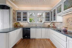 2424 Medford Court – Etched glass cabinet fronts mirror the homes diamond grid cottage windows.