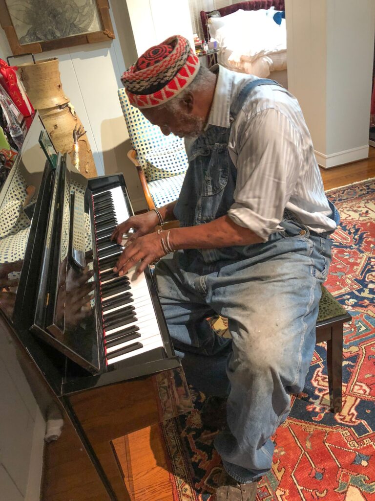 Jesse Lott plays the keyboard. In addition to his work in visual arts, Lott also mastered numerous musical instruments including guitar, bass, and, pictured here, keyboard. (Photo by Ernesto Leon)