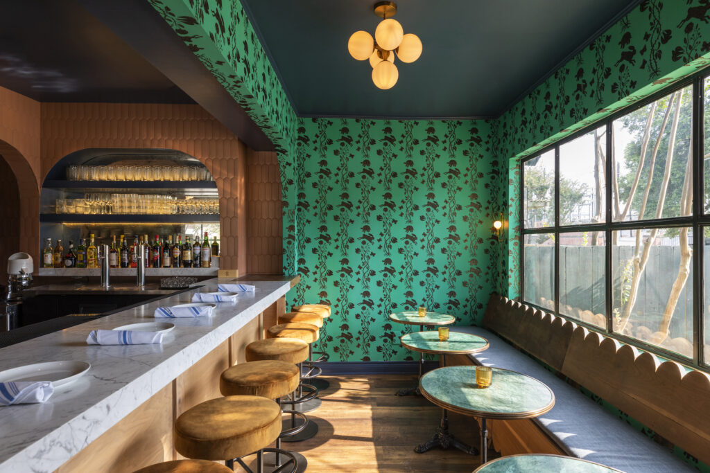 At Elro Pizza and Crudo, designer Betty Maccagnan has installed Art Deco pendants and globe lighting, a Carrara-marble-topped bar, and two color ways of the whimsical Hygge & West Fable wallpaper where the tortoise and the hare play out the childhood classic tale. (Photo by Julie Soefer)