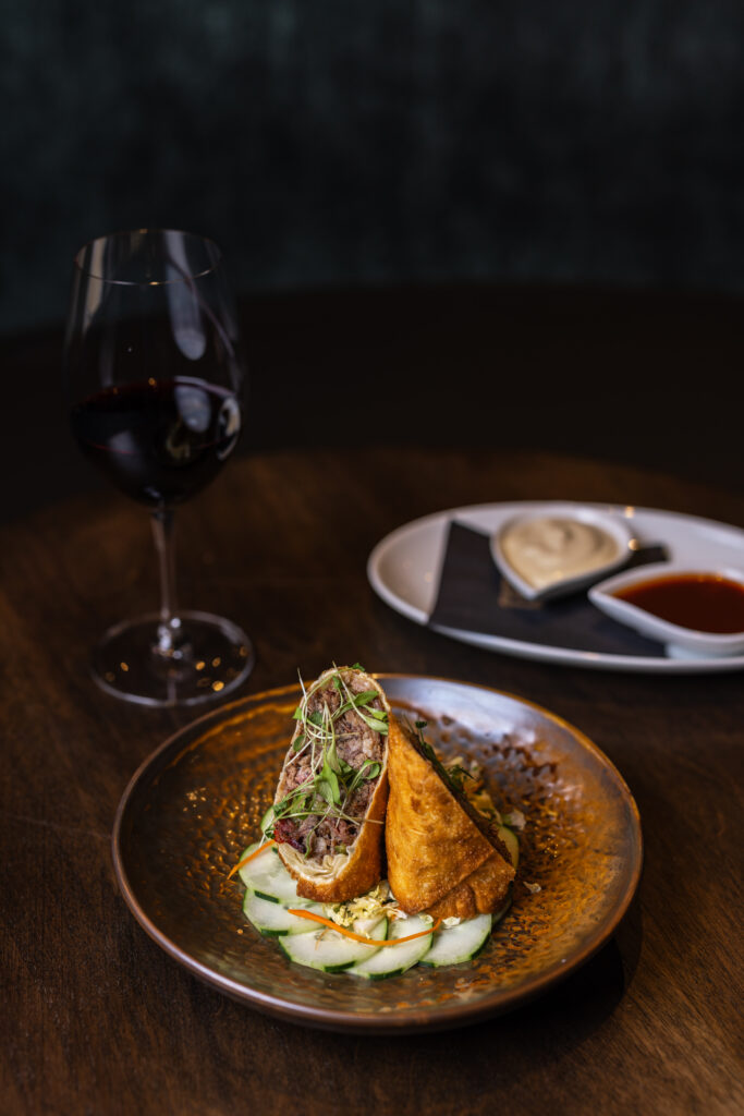The rich smoked brisket egg roll is made with neighbor Truth BBQ own smoked brisket and served with a minced Asian slaw, mustard, and Chinese BBQ sauce ($17). (Photo by Norton Creative )
