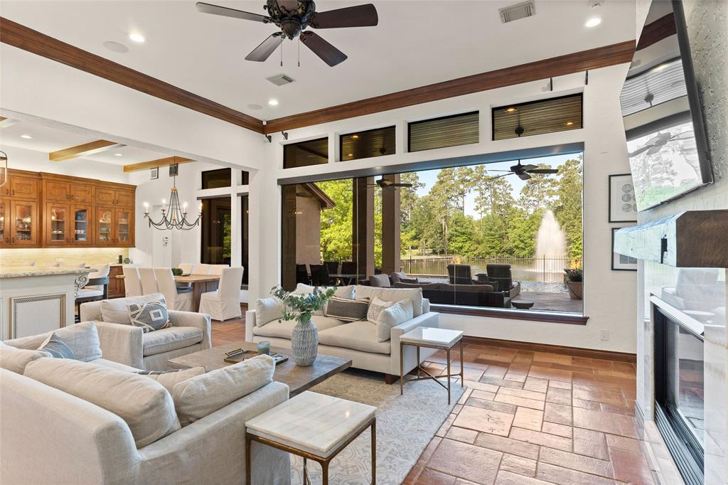 The idyllic living spaces in the house offer beautiful views of the pond and water fountain. 