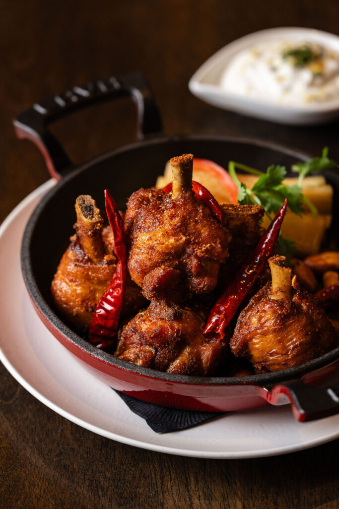 The tender dark-meat Mala spiced chicken lollipops singe your tongue a little before your palate is cooled with minted yogurt sauce ($16). (Photo by Norton Creative )