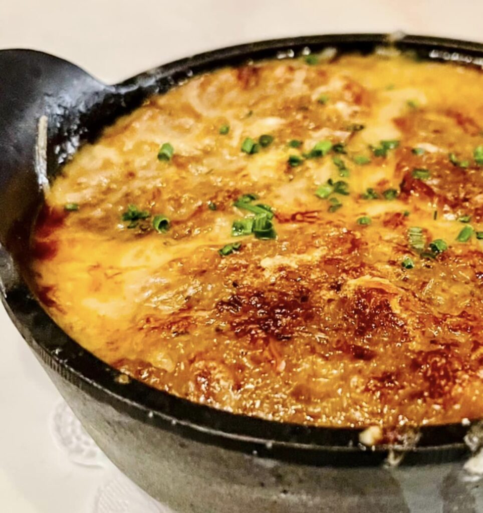 Paris 7th - French Onion Soup Les Halles topped with bubbly Gruyere cheese.