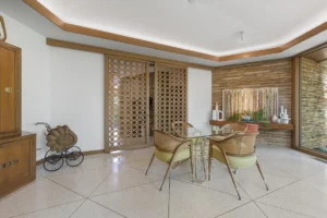 Brachman – Stonework wraps inside walls with plenty of wood trim and glass walls