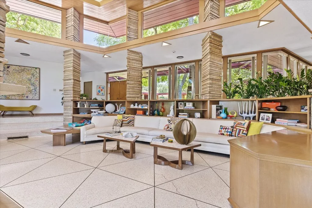 Triangular shapes repeat, in the flooring, lighting soffits and stone pillars.