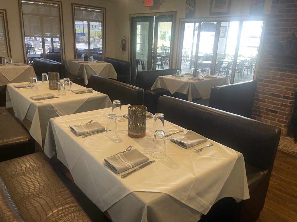 The dining room inside The Butler House has handcrafted tables and beautiful linens.