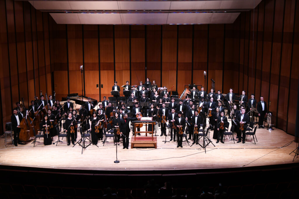 The TMF Orchestra stands for a bow at the final concert of the Texas Music Festival (Photo by Jeff Grass)