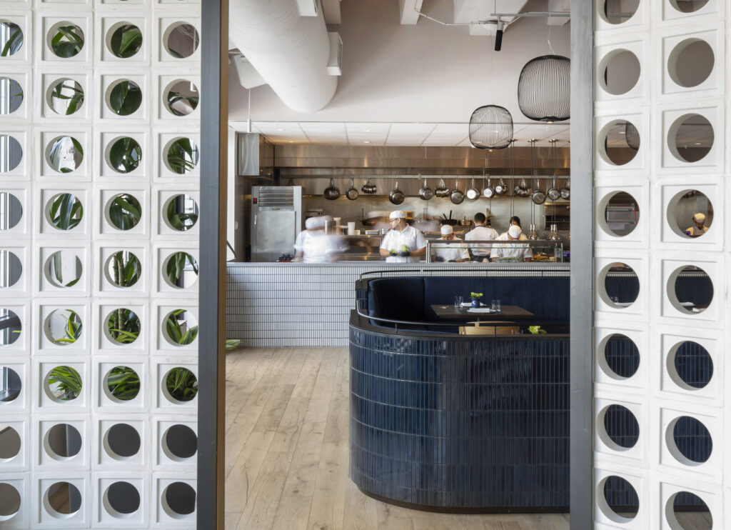 A peek inside the open kitchen from the dining room of Navy Blue in Rice Village shows its restaurant power. (Photo by Julie Soefer)