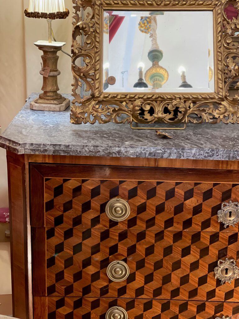 A mid-1800s commode with cube parquetry, one of Lily Barfield's many finds.