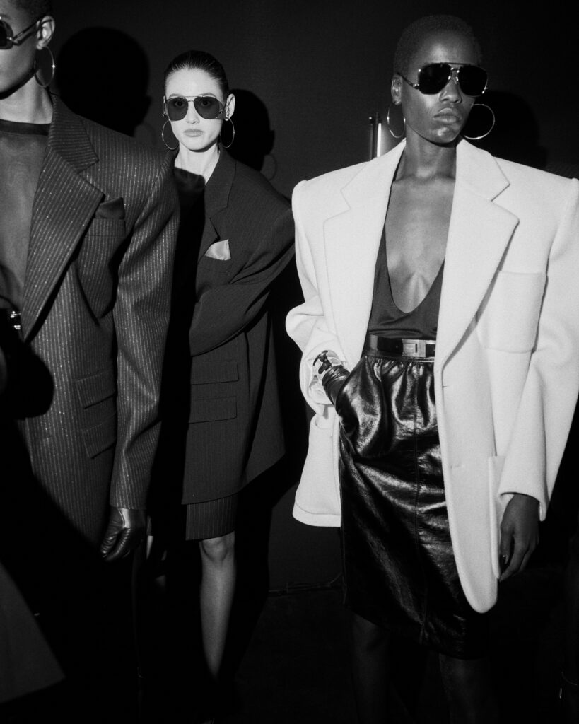 Backstage at the Saint Laurent show - See-through tops and bare chests under sporty blazers from Saint Laurent.