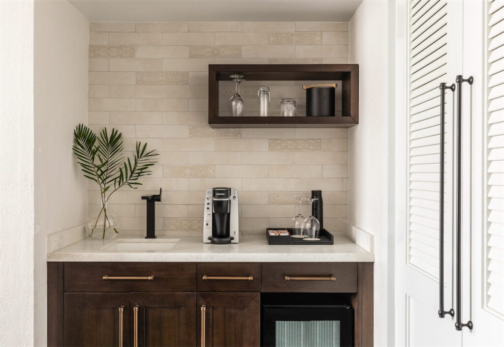 A wet bar offers a Keurig coffee maker, mini fridge, and sink in guest rooms. (Courtesy of The Mills House)