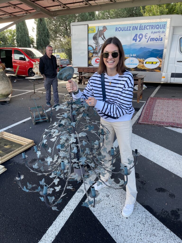 Lily Barfield, founder of Lily's Vintage Finds, with a vintage French tole chandelier discovered on a shopping trip in France.