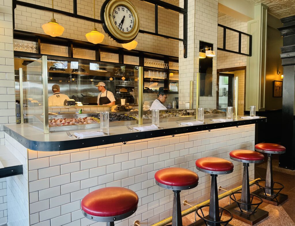 Vintage stools line the raw bar at Walloon's. (Photo by Courtney Dabney)