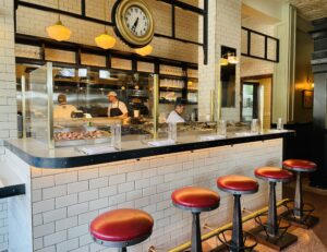 Walloon’s – Vintage stool line the raw bar at Walloon’s. (Photo by Courtney Dabney)