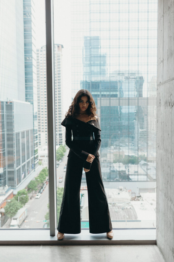 The Tux All Day jacket has an off the shoulder neckline and adjustable buttons for a defined waist. The matching pants are equipped with front pockets and feel like silky yoga pants.