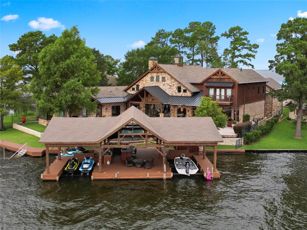 The boat house at 9144 Escondido Drive has two boat slips and slips for two jet skis.  (Photo by EmoMedia/Compass)