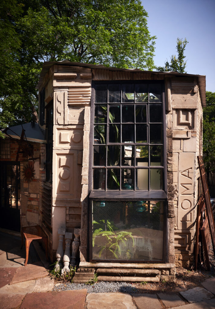 Bellamy built an orchid room with salvaged stone architectural elements and industrial windows. (Photo by Pär Bengtsson)