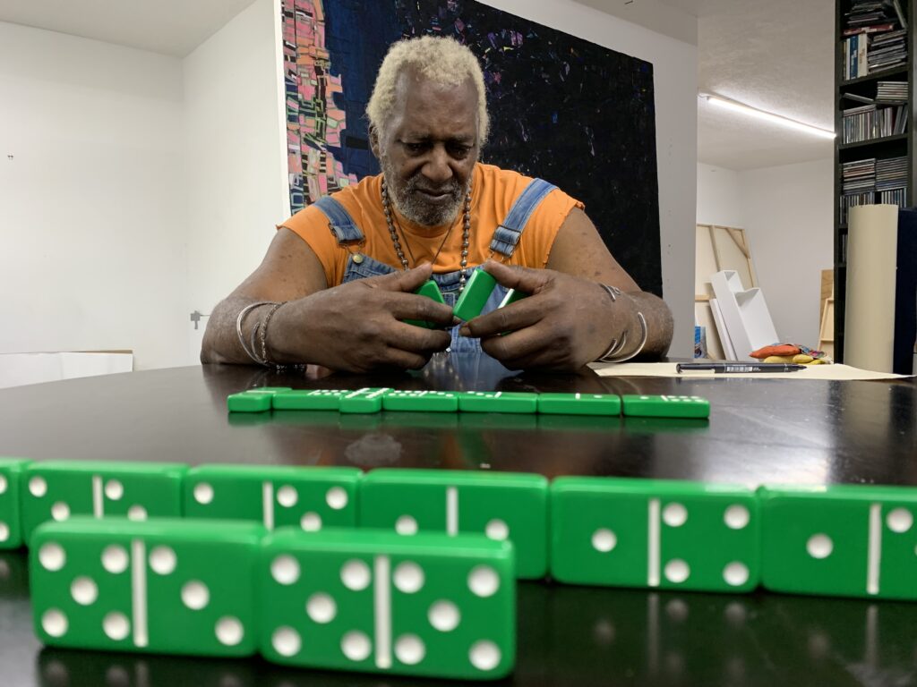 Jesse Lott concentrates on his strategy during a dominoes game. Playing dominoes with Rick Lowe was a favorite pastime of Lott's. (Photo by Ernesto Leon)