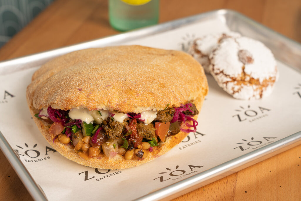 ZOA's Casablanca Sandwich is layered with lamb meshwi, taktouka, cucumber, tomato, white beans, pickled red onion cabbage and drizzled with a garlic aioli sauce.   (Photo by ZOA's Shawn Chippendale)