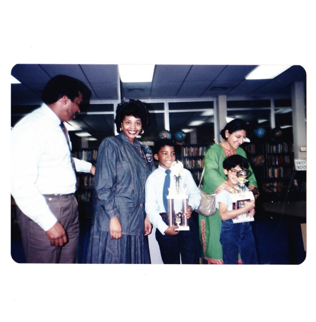 Artist El Franco Lee II receives an award for his art in 1988 at Will Rogers Elementary School. From left: the late Harris County Precinct One county commissioner El Franco Lee, his wife, Ethel Kaye Lee, El Franco Lee II, a parent and classmate. (Courtesy El Franco Lee II)