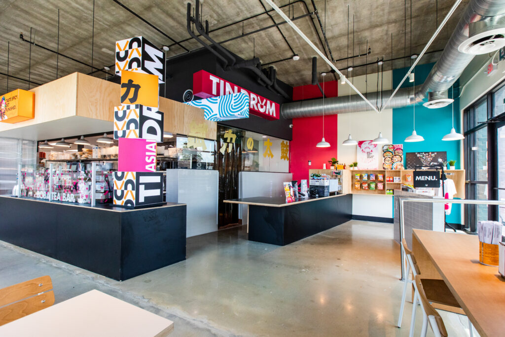 Houston's new Tin Drum restaurant features 50 seats inside and a patio outside. There is also a playful decor replete with graffiti, pops of colorful art, and neon lights. (Photo by Becca Wright)