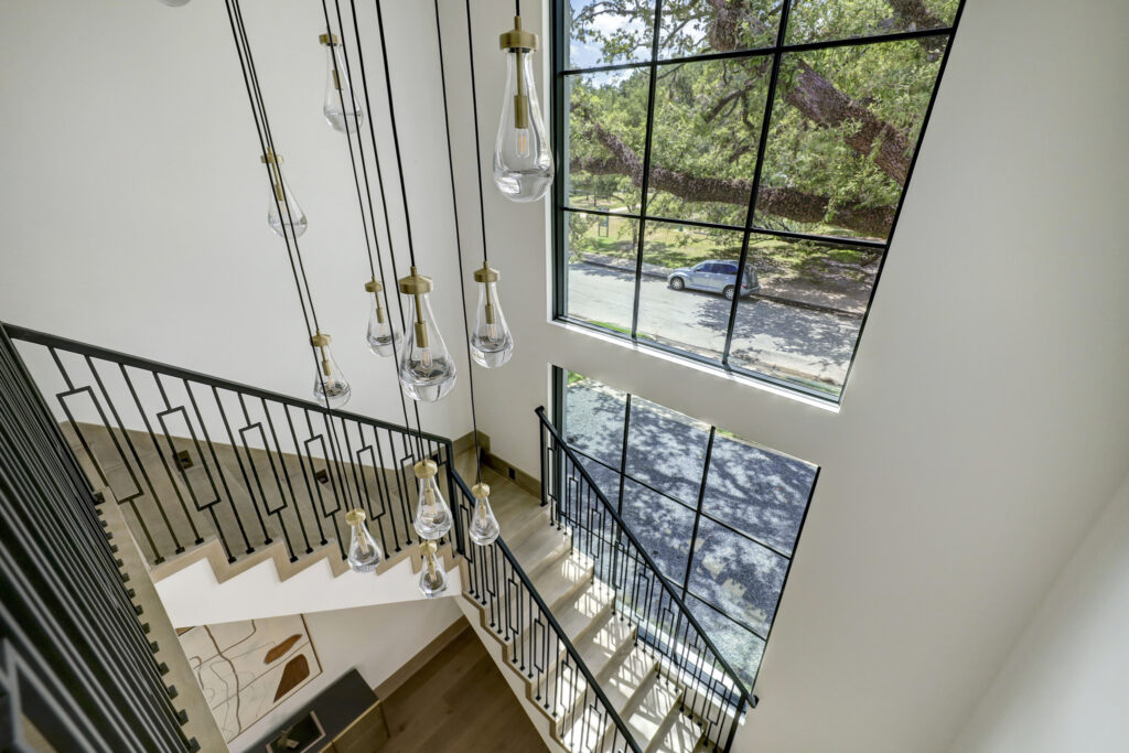Views to the outdoors from the two-story windows in the 23-foot tall stairwell. (Photo by TK Images for Compass)