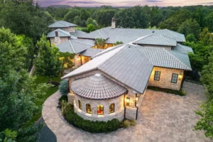 Six – 2006 Nighthawk Court – with its tile roof and stone facade