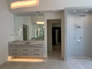 Six – 7239 Oak Valley – The expansive primary bath includes floating vanites, a soaking tup and an open rain shower