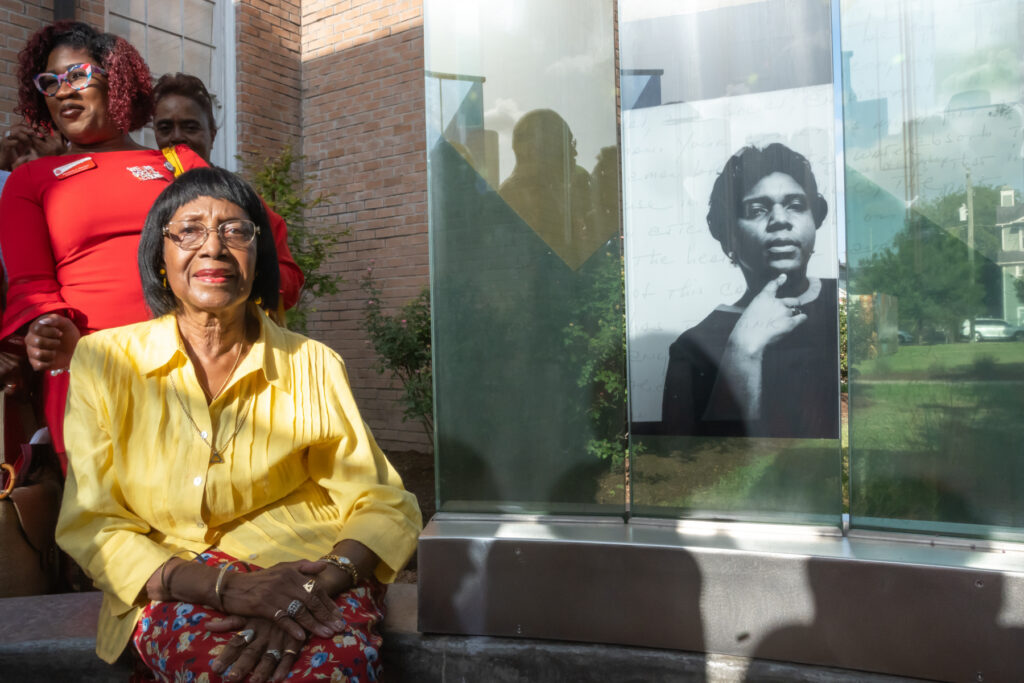 Rose Mary McGowan poses next to the image of her sister Barbara Jordan. The monument, located at the African American Library at the Gregory School, is the first in Houston dedicated to Jordan’s memory. (Photo by Ken Jones Photography/Dennis Rogers)