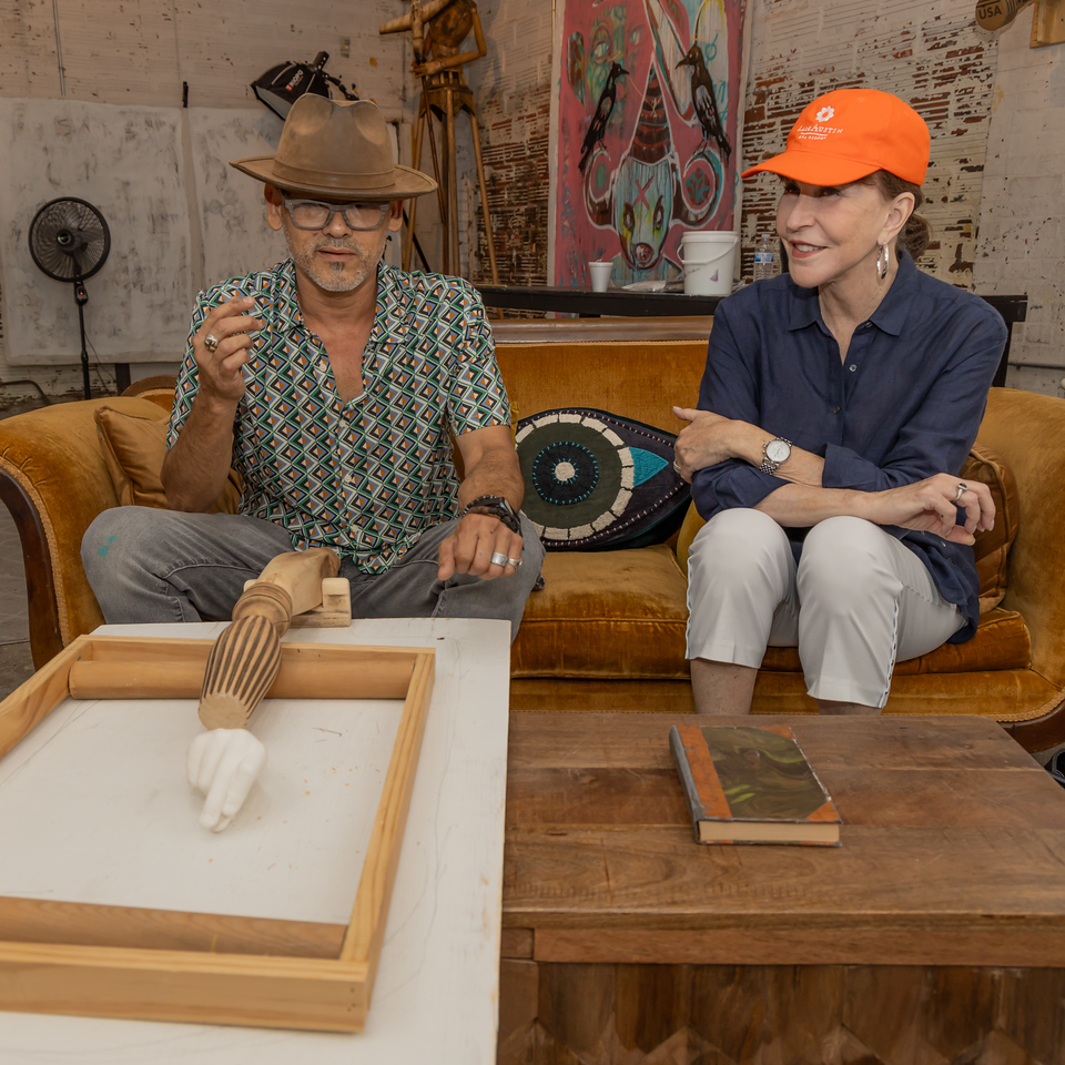 Artist Patrick Medrano explains to Shelby Hodge the artwork that he is designing for the Houston Arts Alliance Gala.  (Photo by Katy Anderson)