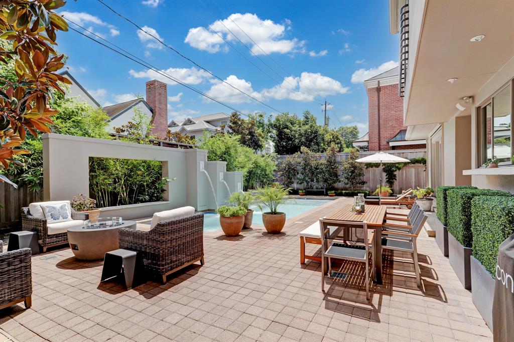 With a pool, wall water feature, and fire pit, 3207 Ferndale's backyard leaves little to be desired. (Photo by TK Images)