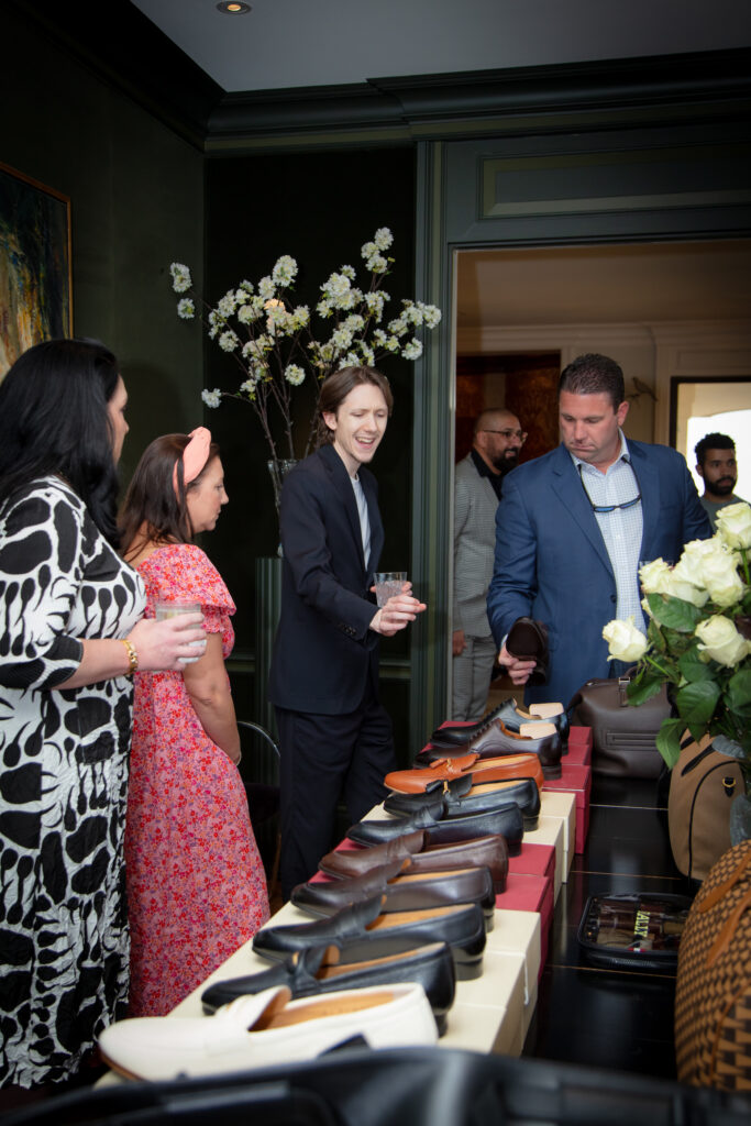 Guests peruse the men's footwear at the Bally cocktail event benefiting Juvenile Diabetes Research Foundation. (Photo by Kara Trail, Miroma Photography)