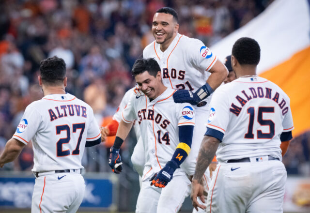 Yainer Diaz is so excited by Mauricio Dubon walking it off in the bottom of the ninth that he jumps on for a ride. (Photo by F. Carter Smith)