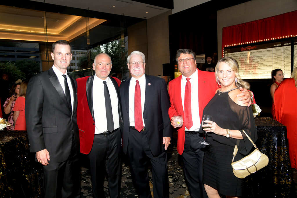 UH athletic director Chris Pezman (red jacket, black tie) is always at home with other UH devotees.