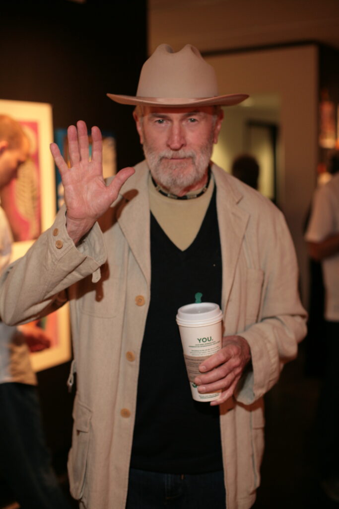 The gallerist was never without his Starbucks.