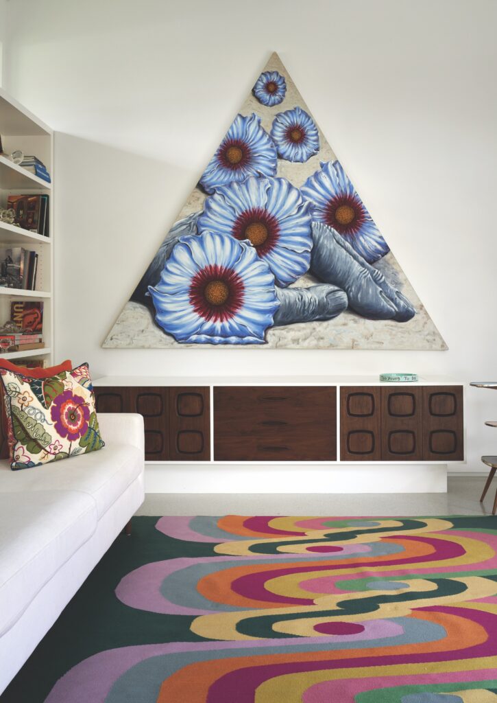 In the library, a custom rug by Vanderhurd. Wayne Gilbert painting. Custom TV console by Hayes Carpentry.  (Photo by Pär Bengtsson)