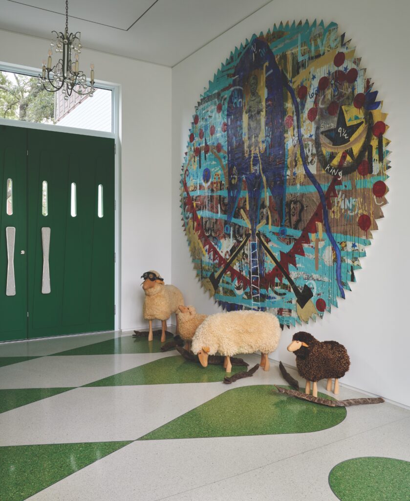 Custom front door with terrazzo door pulls. Antique crystal chandelier, Angelbert Metoyer painting. Tonio Trzebinski’s crocodiles, Hanns-Peter Krafft’s sheep stools from Thorsten Van Elten. (Photo by Pär Bengtsson)