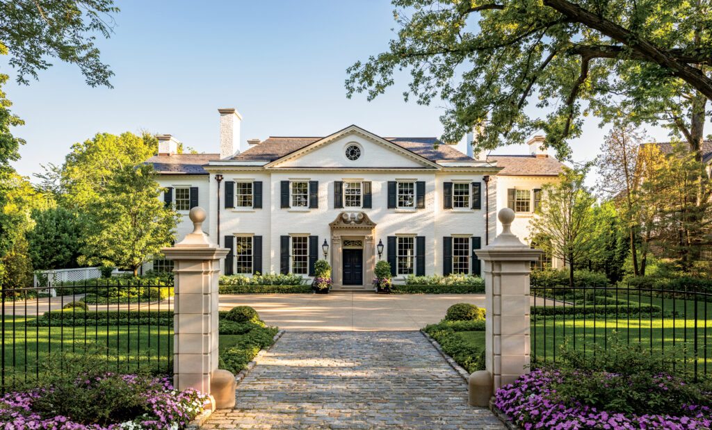 A stately home designed by D. Stanley Dixon with reclaimed limestone piers that flank a granite driveway, which leads to a gravel motor court. (Photo by Eric Piasecki)