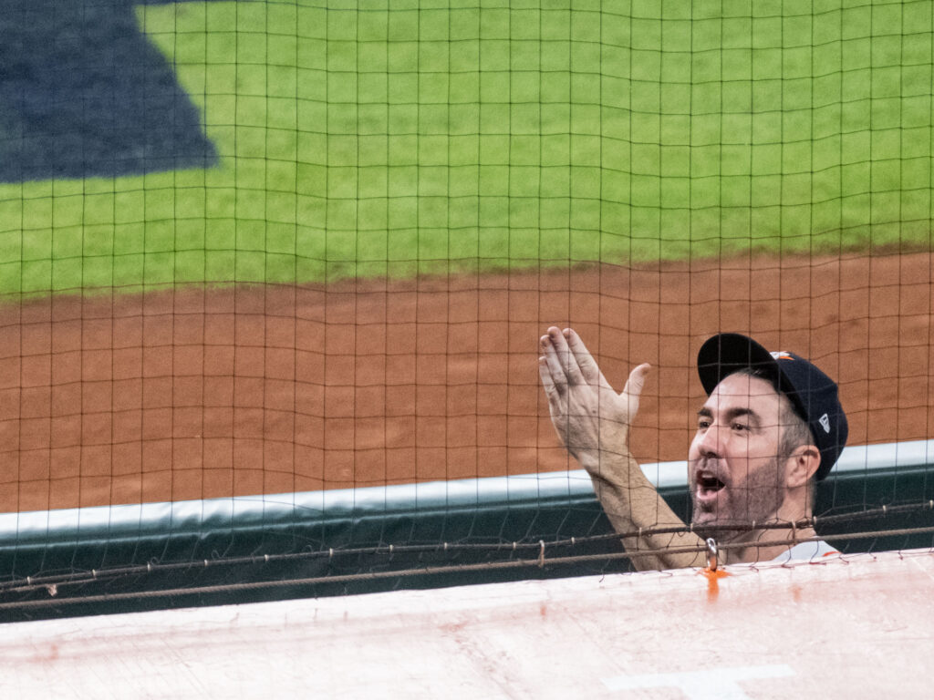 Justin Verlander waved up to Kate Upton and his daughter after another playoff win. (Photo by F. Carter Smith)