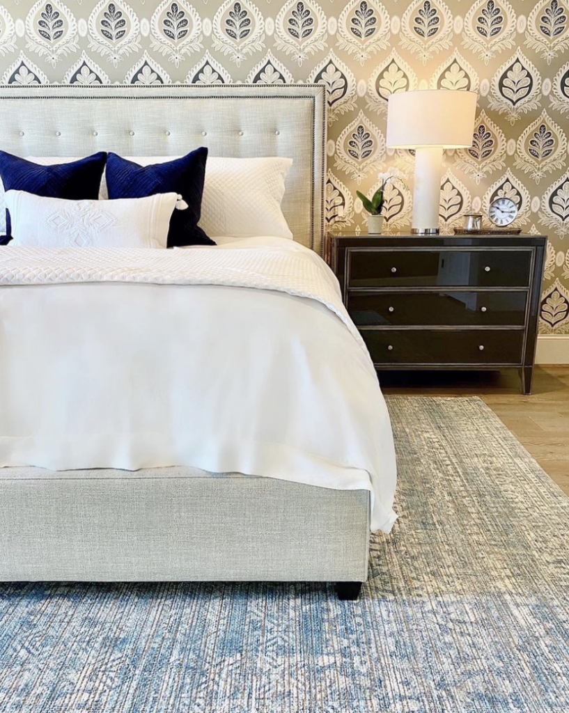 A client's guest bedroom got a makeover with new paint, an area rug, new bedding and furniture. 