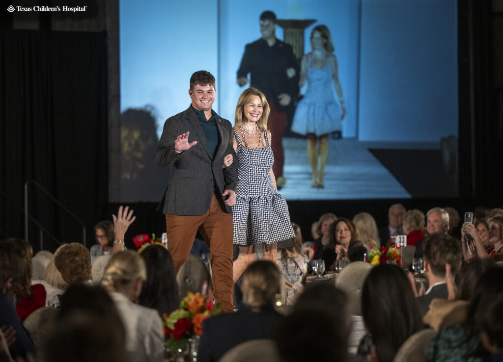 Cheryl Byington escorts Patient Champion Trace at the 12th annual fundraiser for Texas Children's Cancer and Hematology Center.  (Photo by Texas Children's Hospital)